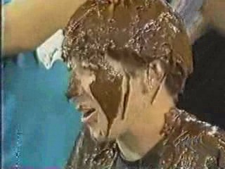 A women has chocolate poured over her head