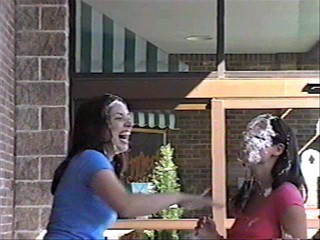 Two girls pie each other